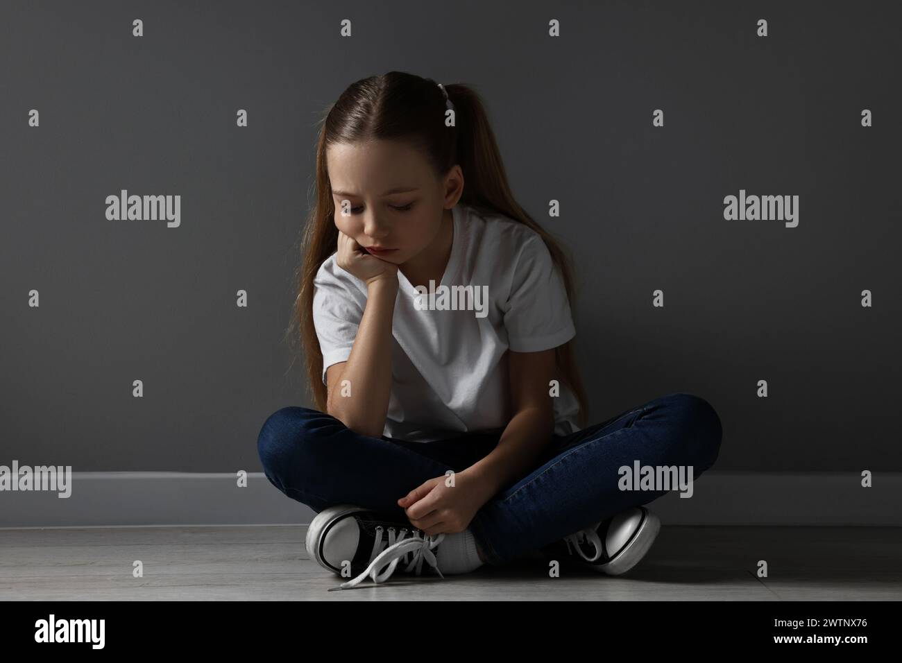 Upset girl sitting on floor hi-res stock photography and images - Alamy