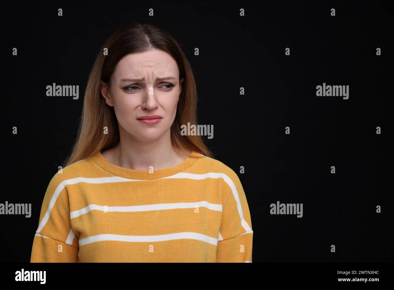 Portrait of sad woman on black background, space for text Stock Photo ...