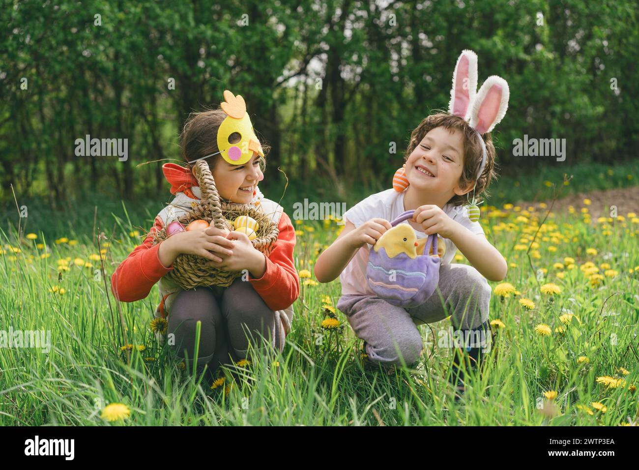 Easter Egg Hunt Two Children Hunt For Easter Eggs In A Spring Garden