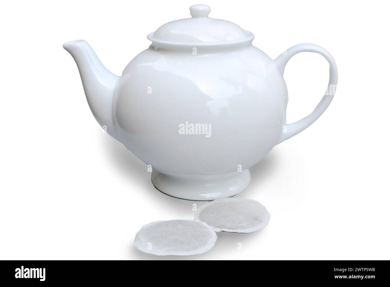 Teapot and teabags isolated on white background. Stock Photo