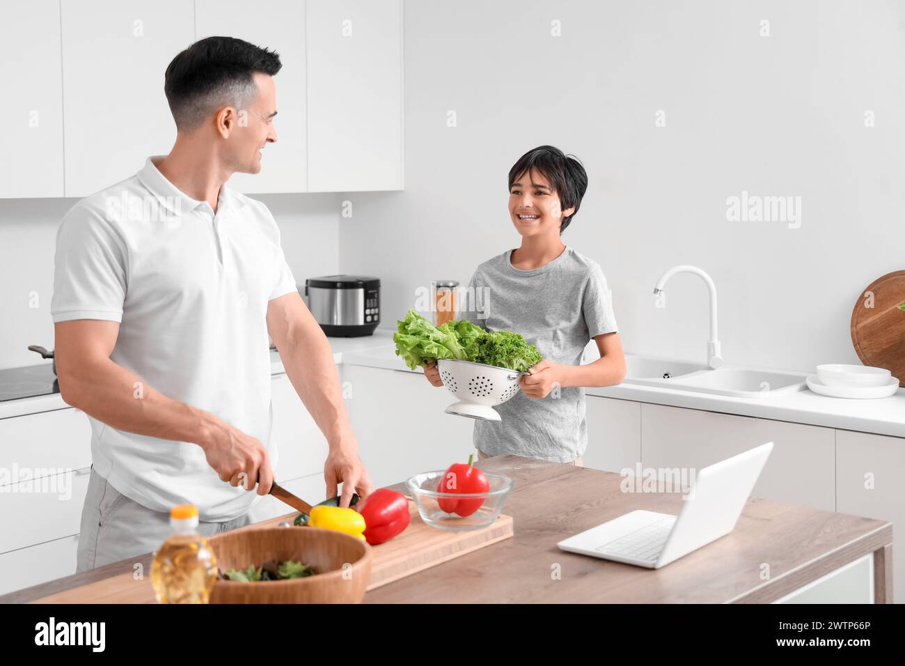 Little boy with his father cooking in kitchen Stock Photo - Alamy