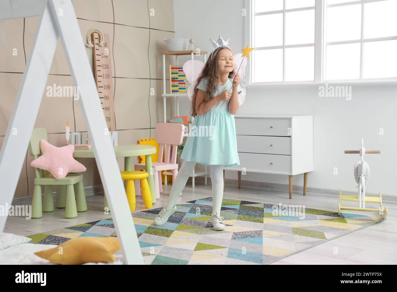 Little girl dressed as fairy with wand in bedroom Stock Photo - Alamy