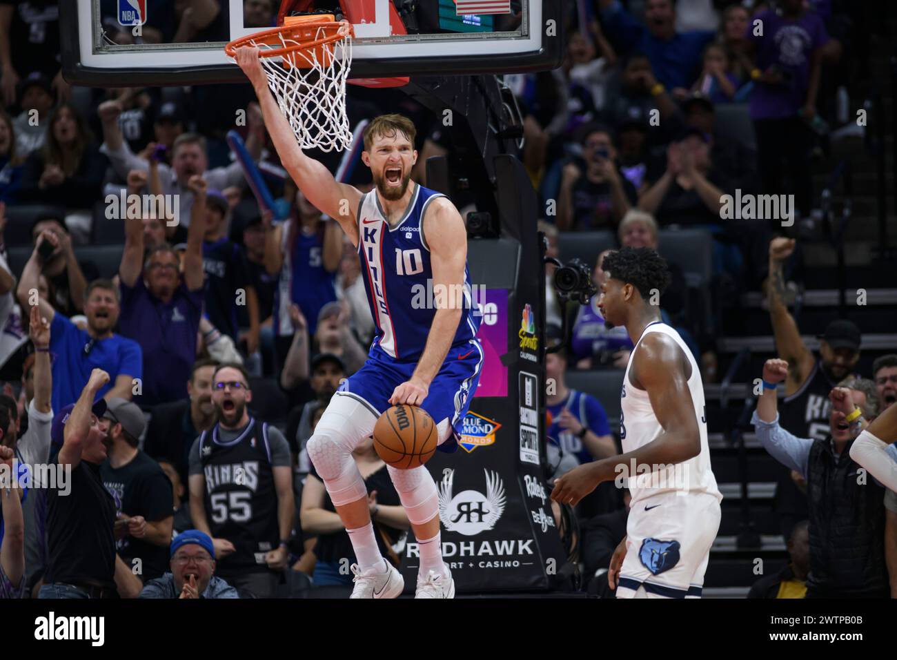 Sacramento Kings forward Domantas Sabonis (10) reacts after dunking the ball during the second half of an NBA basketball game against the Memphis Grizzlies in Sacramento, Calif., Monday, March 18, 2024. The Kings won in overtime 121-111. (AP Photo/Randall Benton) Stock Photo