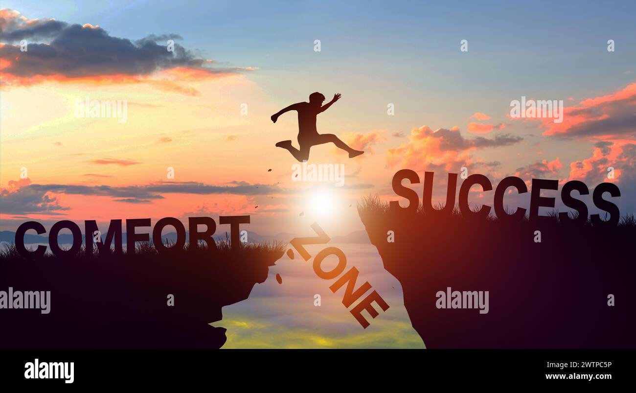 Silhouette man jumping form cliff to another mountain with Comfort zone to Success. Successful in business Concept. Copy space. Stock Photo