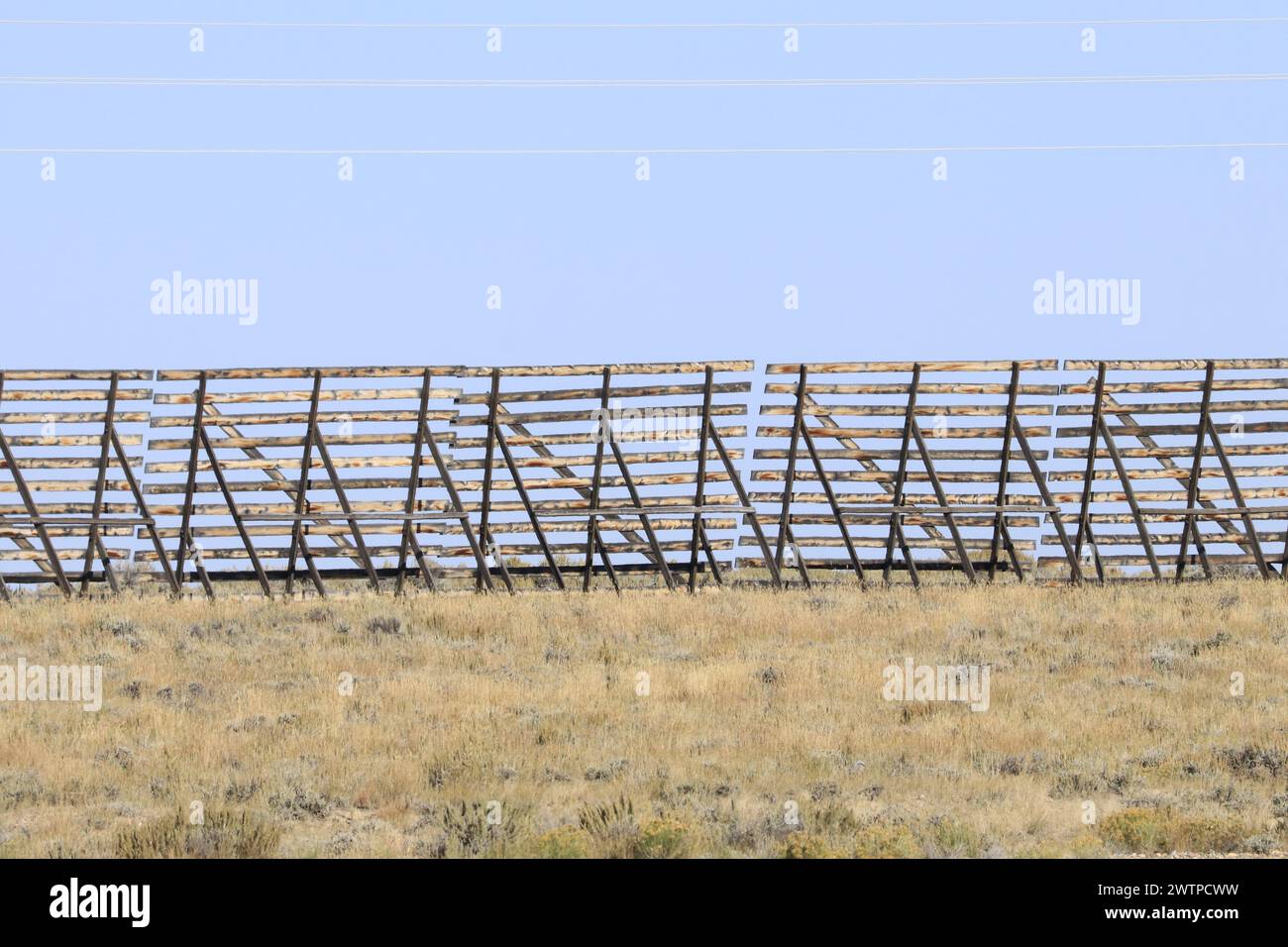 Snow Fence with blue sky that's west of Laramie Wyoming Stock Photo