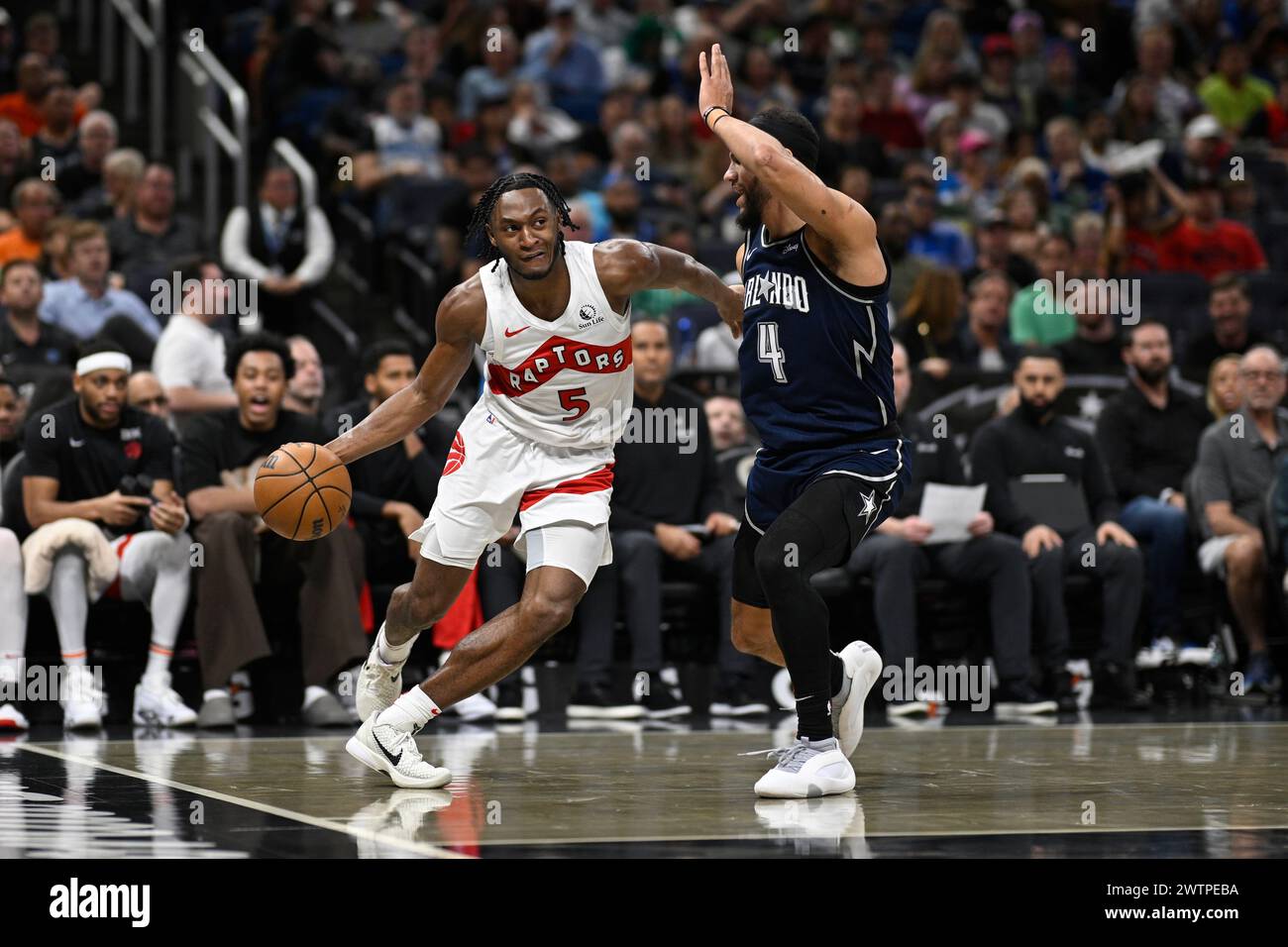 Toronto Raptors guard Immanuel Quickley (5) is defended by Orlando ...