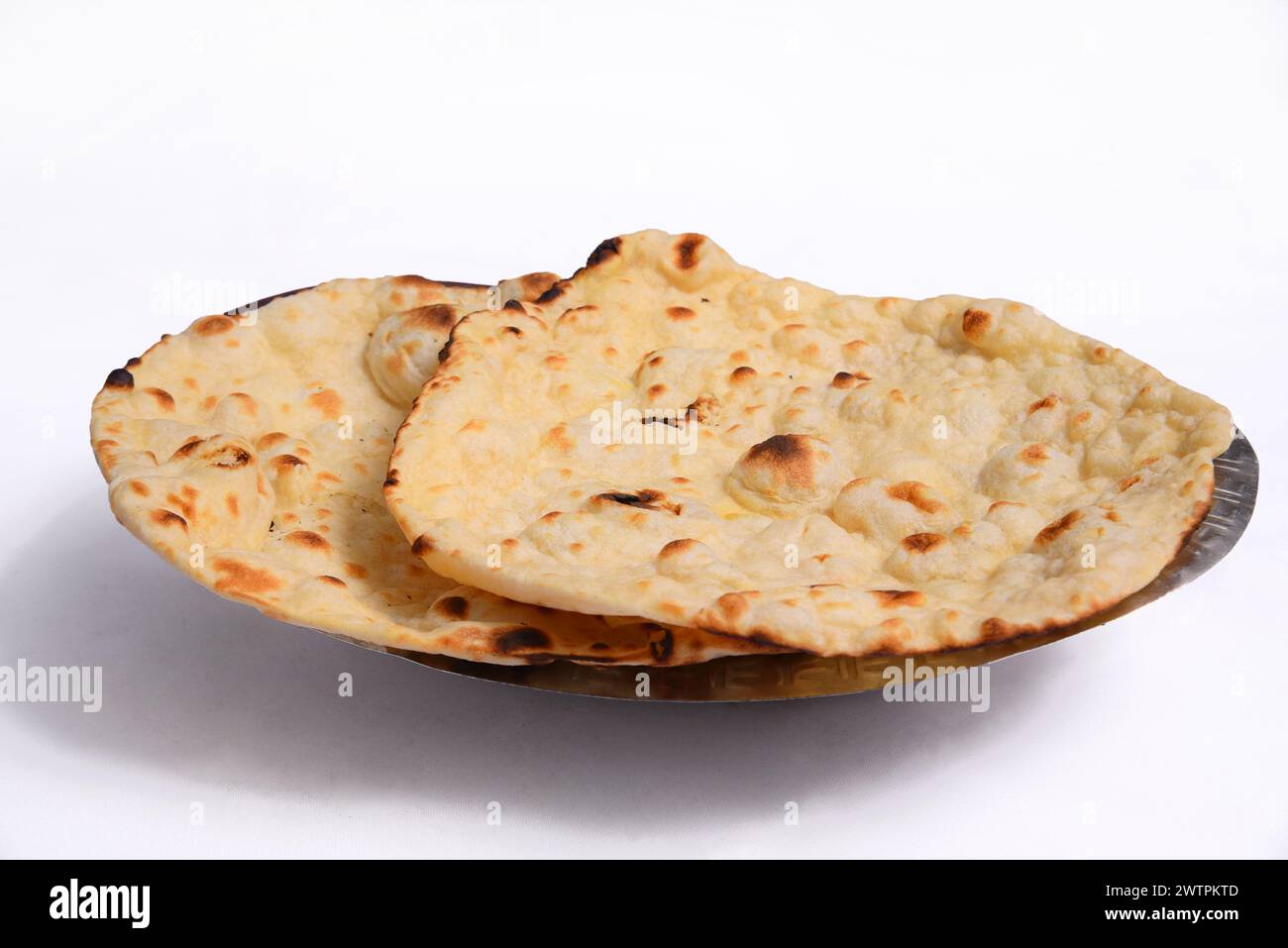 Tandoori roti are flatbreads made with whole wheat flour and cooked in a tandoor, a clay oven.Served on a plate with a close-up view isolated. Stock Photo