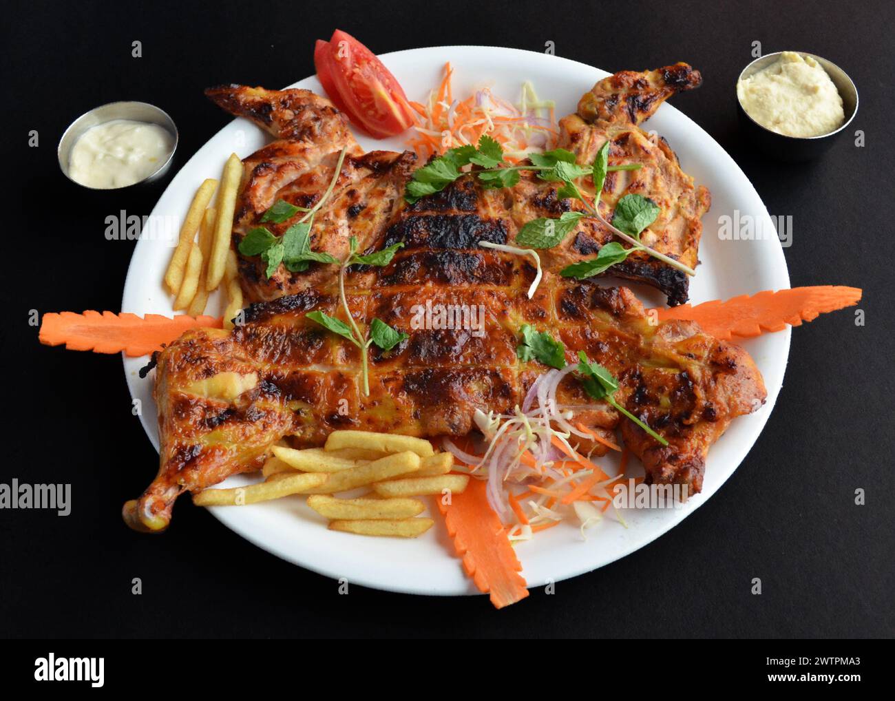 Alfahm is an Arabic grilled chicken marinated with Arabian spice and barbecued in charcoal. Stock Photo
