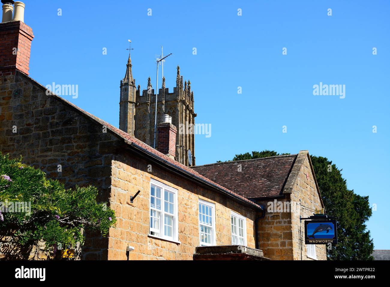 Front view of the Dolphin Inn along Silver Street in the town centre with the minster tower to the rear, Ilminster, Somerset, UK, Europe. Stock Photo