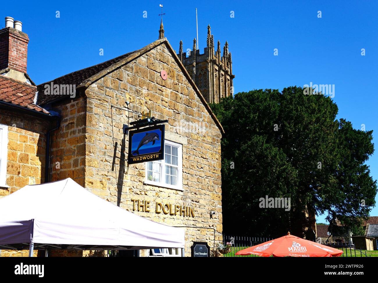 Front view of the Dolphin Inn along Silver Street in the town centre with the top of the minster tower to the rear, Ilminster, Somerset, UK, Europe. Stock Photo