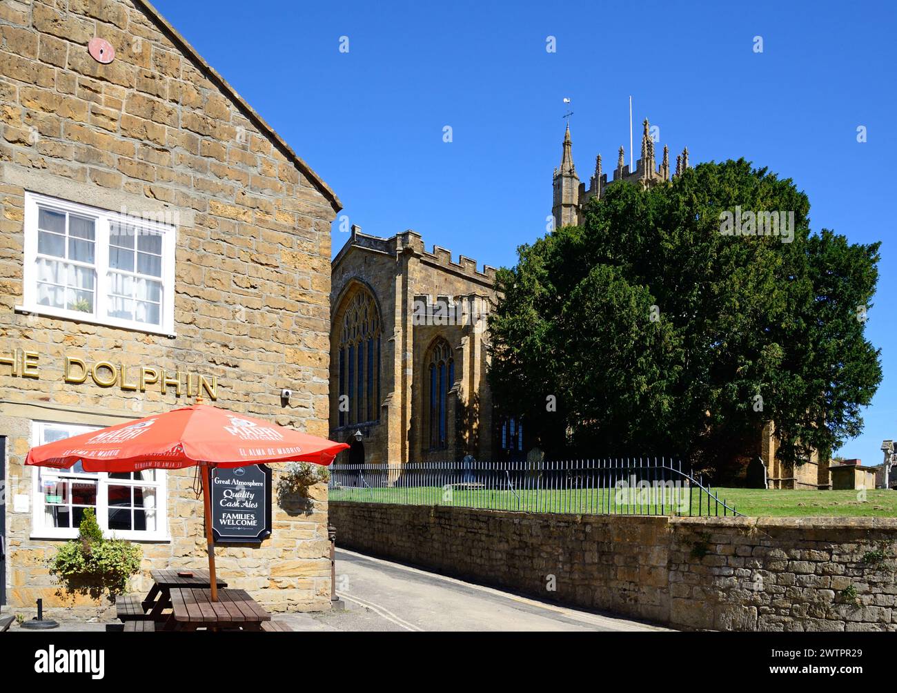 Front view of the Dolphin Inn along Silver Street in the town centre with the minster tower to the rear right, Ilminster, Somerset, UK, Europe. Stock Photo