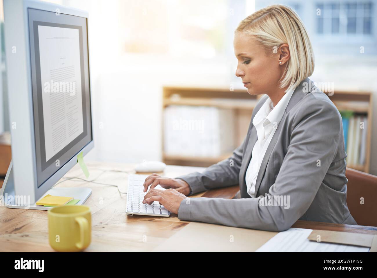 Lawyer, woman and typing in office with computer for legal services with thinking, knowledge and ideas. Attorney, advocate and person with pc for Stock Photo