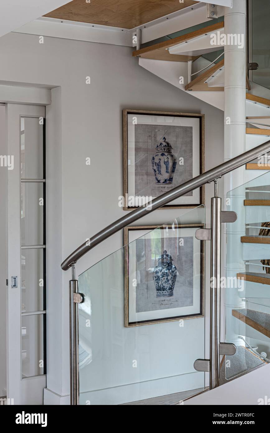 Framed artwork of urns with spiral staircase in British home in Blakeney, Norfolk, UK Stock Photo