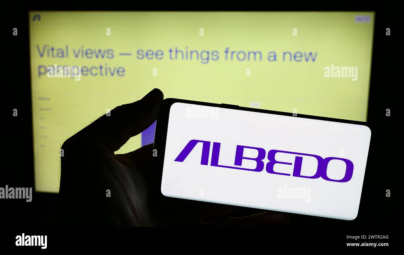 Person holding smartphone with logo of US aerospace company Albedo Space Corp. in front of website. Focus on phone display. Stock Photo