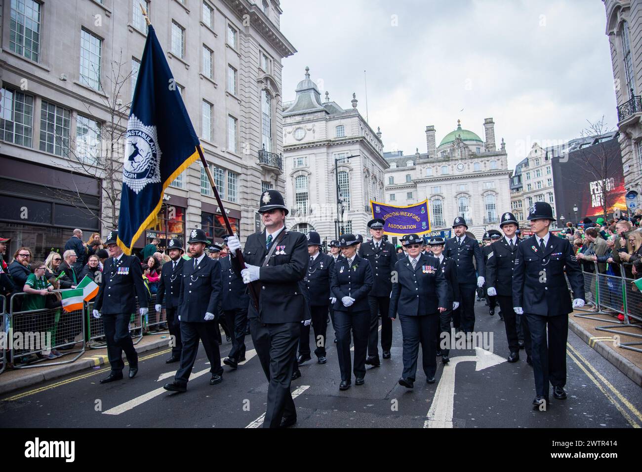 London, UK. 17th Mar, 2024. Police march during the St Patrick's Day Parade. The Mayor's annual celebration has become a highlight of London's cultural calendar as Londoners and visitors unite to celebrate the great contributions Irish people have made to the capital. St Patrick's Day is the ideal opportunity to pay homage to the enduring friendship between the British and Irish people. Credit: SOPA Images Limited/Alamy Live News Stock Photo