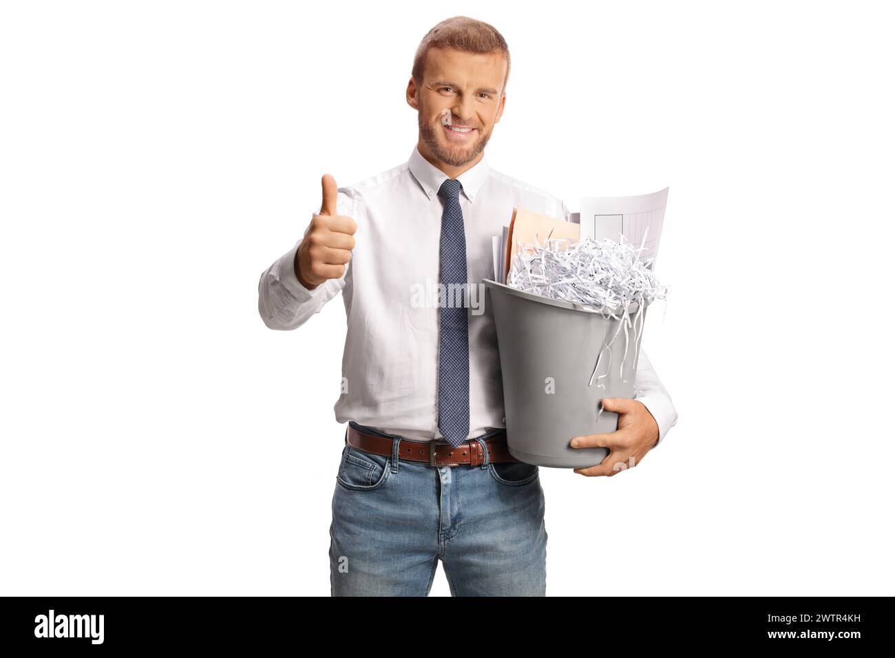 Office worker holding a bin with paper waste and gesturing thumbs up isolated on white background Stock Photo