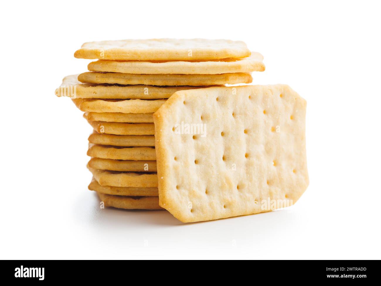 A pile of crackers stacked on a plain white surface. Isolated on white ...
