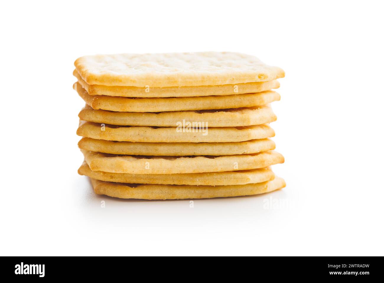 A pile of crackers stacked on a plain white surface. Isolated on white ...