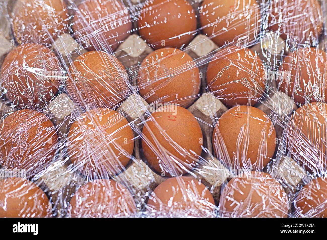 farm chicken eggs in plastic film on the store counter Stock Photo Alamy
