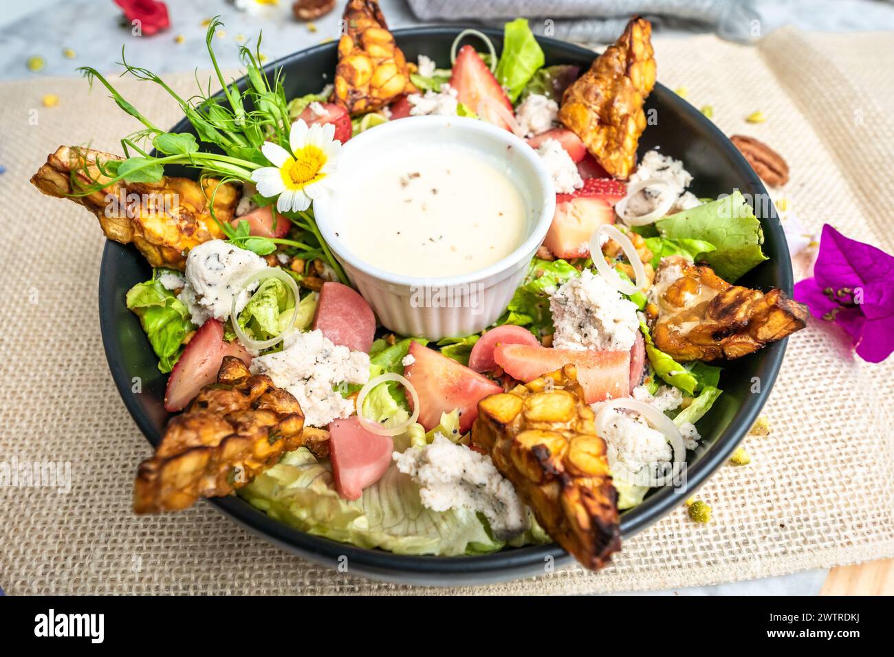Fresh salad with chicken, lettuce, and tomatoes on a plate Stock Photo