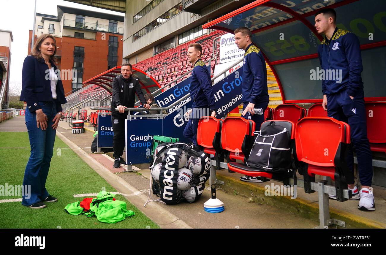 Secretary of State for Culture, Media, and Sport Lucy Frazer with Southend United assistant manager Darren Currie (second left) at Brisbane Road, home of Leyton Orient Football Club, London. Picture date: Tuesday March 19, 2024. Stock Photo