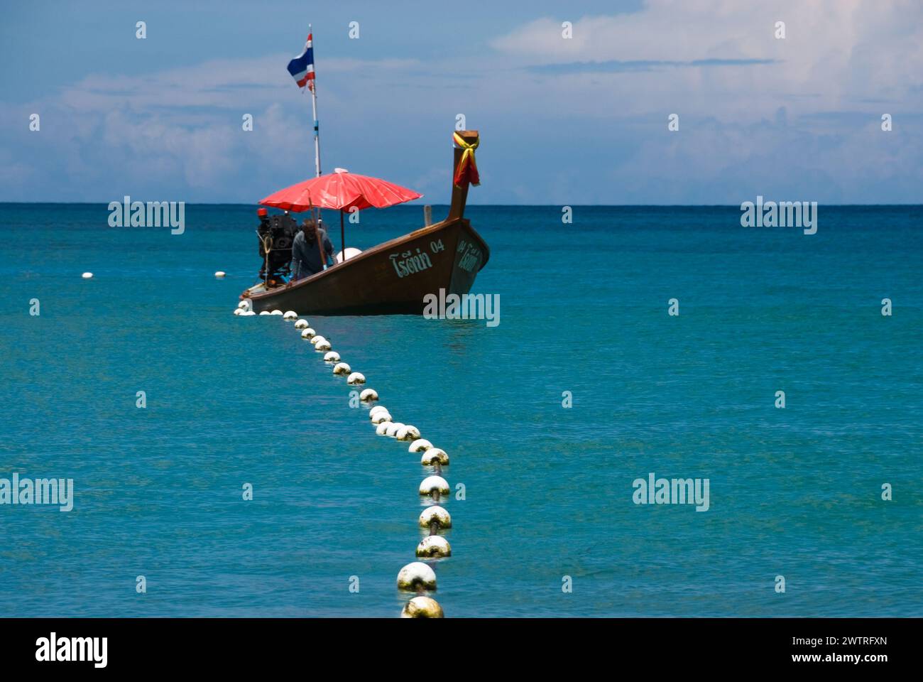 Boat at sea with rope around its hull Stock Photo
