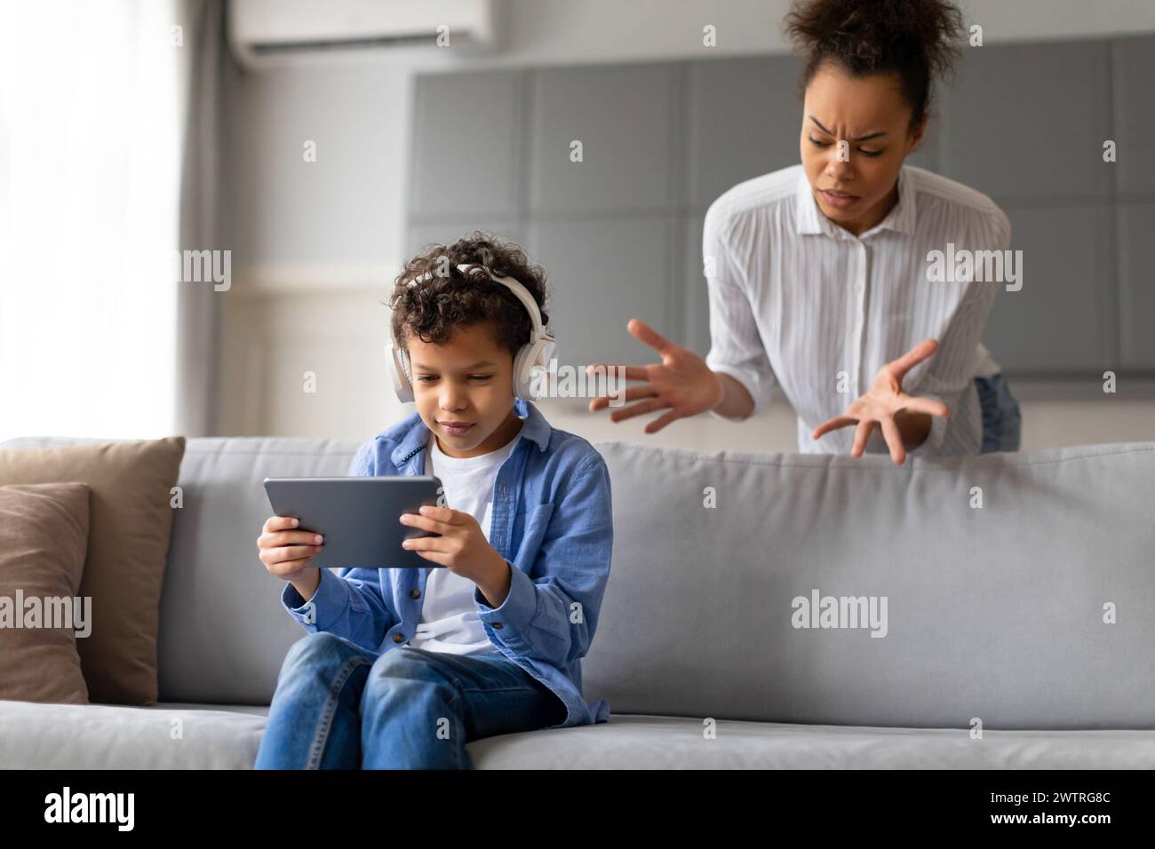 Mother concerned over son's device usage Stock Photo