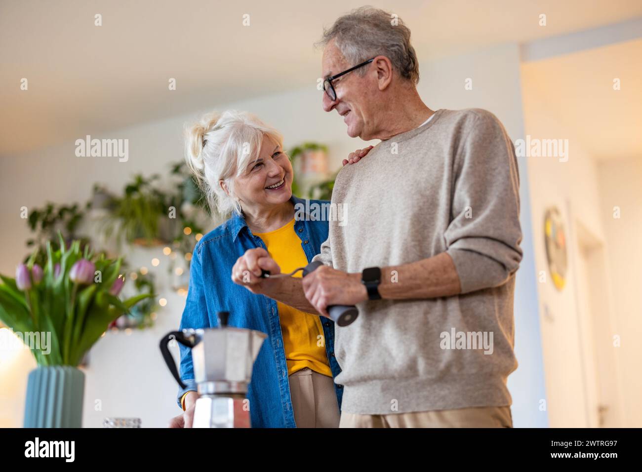 Senior couple preparing coffee at home Stock Photo