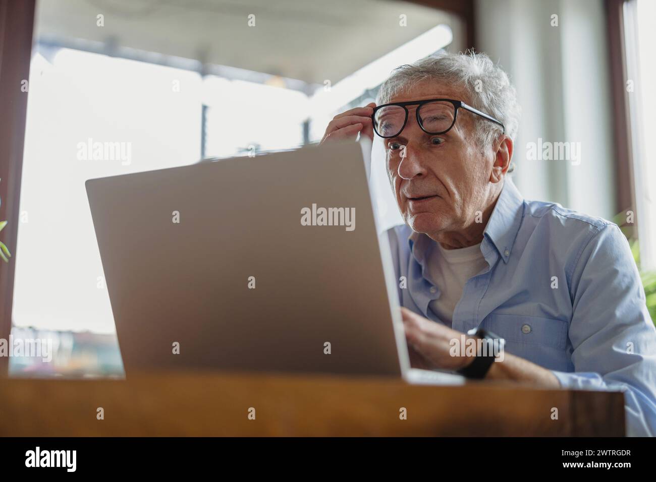 Senior man using laptop at home Stock Photo