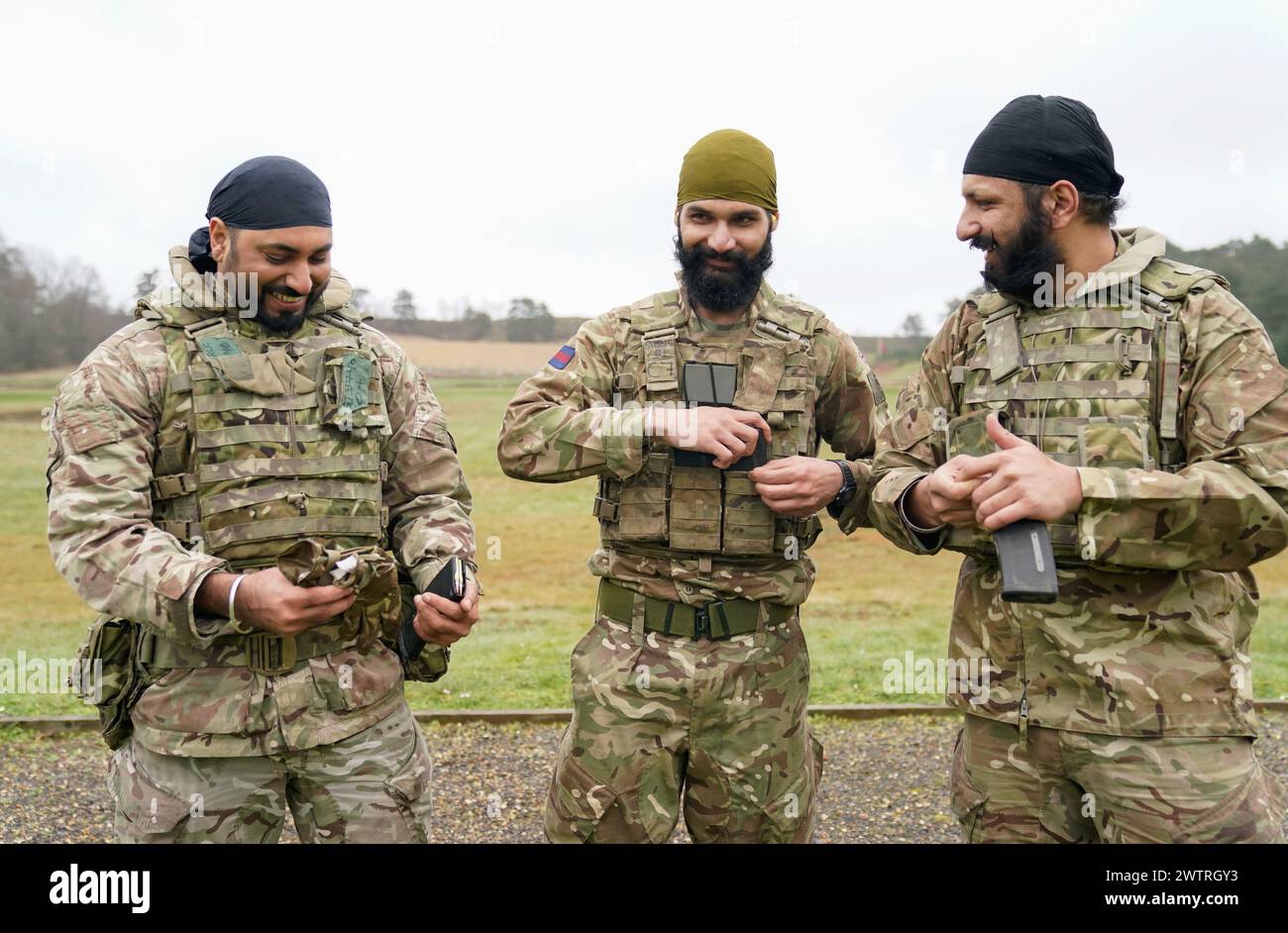 (from left to right) Corporal A Singh, Guardsman K Singh and Corporal MS Lilly during a break in a shooting competition during the Holla Mahalla Sikh military festival, at the Aldershot Garrison, Hampshire. The centuries old Hola Mahalla festival celebrates Sikh martial traditions, and promotes courage, preparation, and readiness. Picture date: Tuesday March 19, 2024. Stock Photo