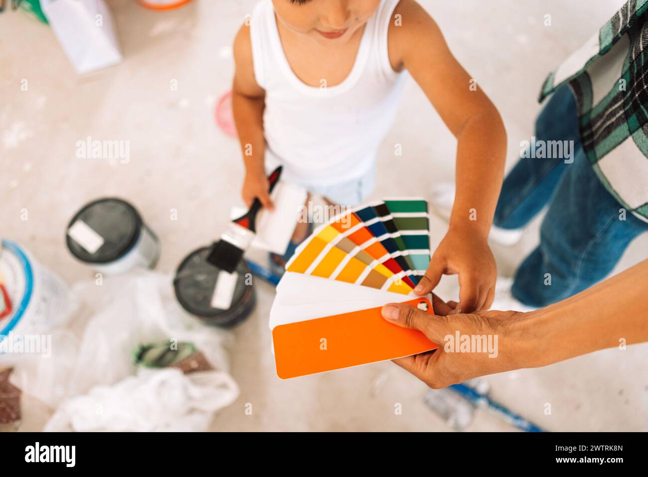 Close-up of a woman hand holding a palette of colors. A cute child ...