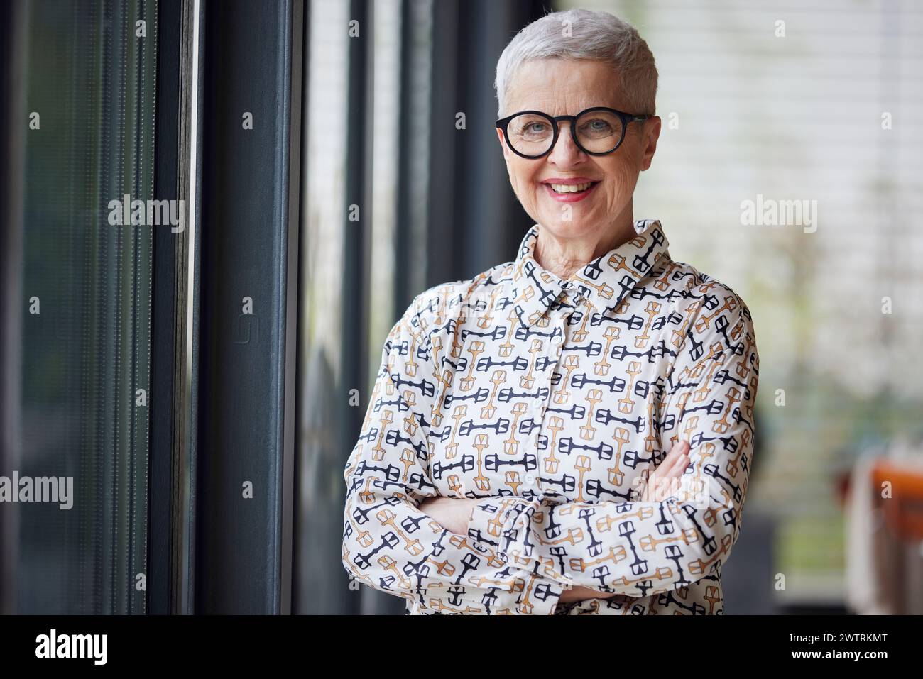 Portrait of smiling senior woman at home Stock Photo