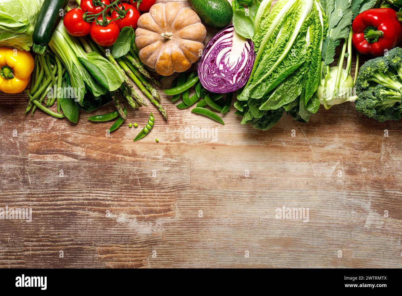 Vegetables background. Various vegetables on kitchen table. Clean eating, healthy food concept, flat lay, top down view Stock Photo