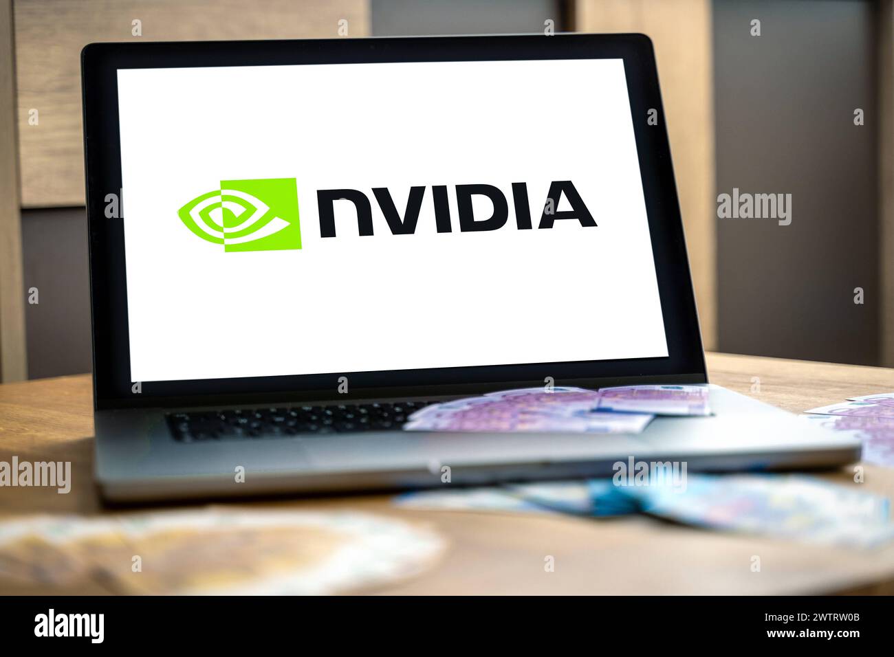 March 19, 2024: Laptop computer stands on a desk, the Nvidia logo can be seen on the screen. PHOTOMONTAGE *** Laptop Computer steht auf einem Schreibtisch, in dem Bildschirm ist das Logo der Firma Nvidia zu sehen. FOTOMONTAGE Stock Photo