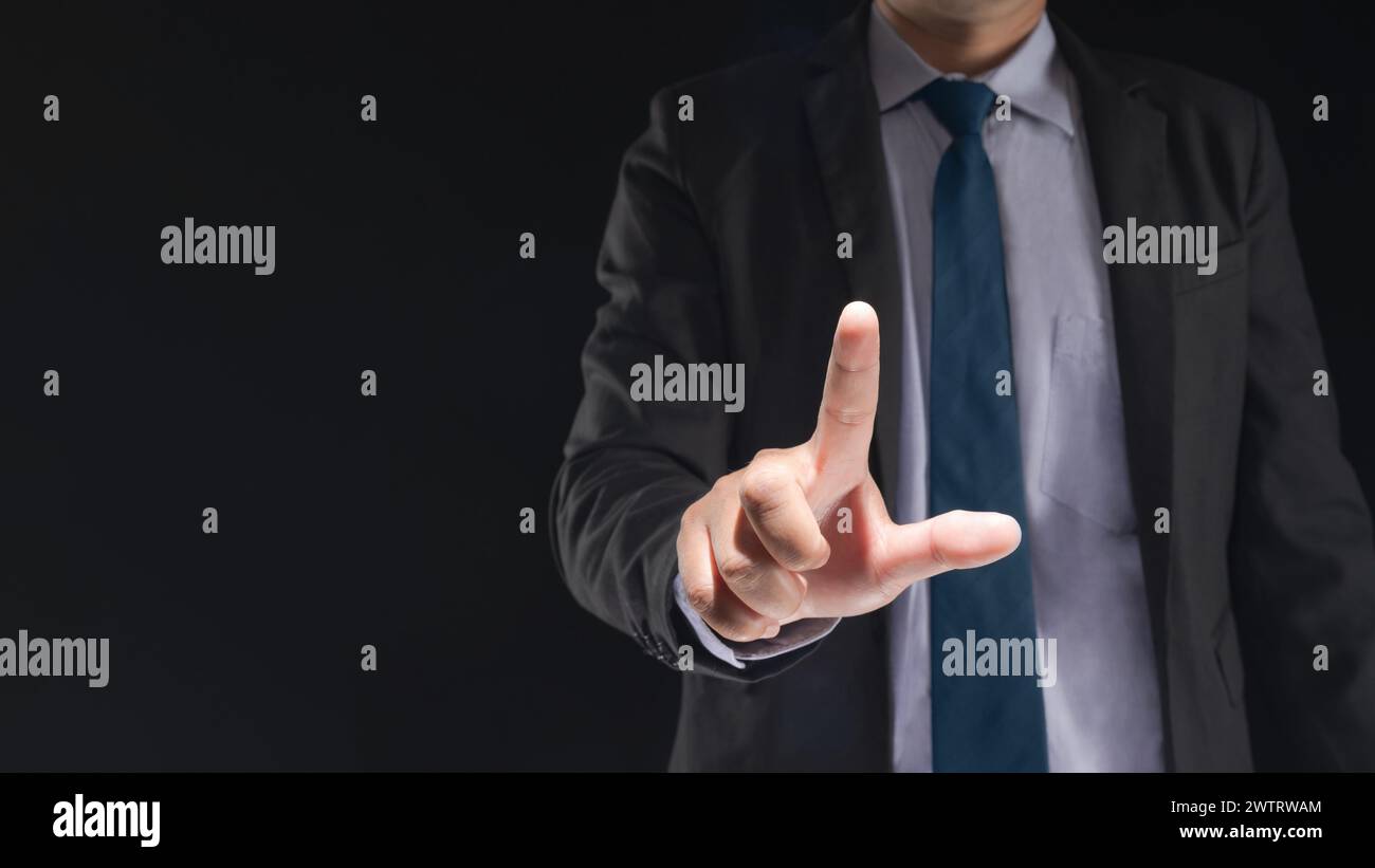 Businessman hand touching virtual screen on black background with blank for copy space Stock Photo