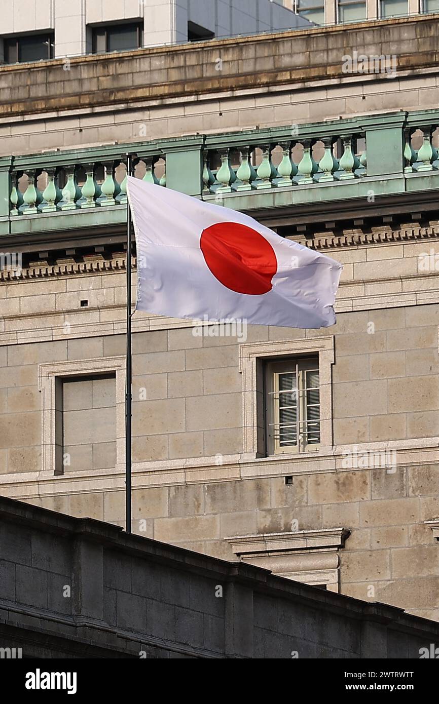 Tokyo, Japan. 19th Mar, 2024. A Japanese flag is seen at the Bank of Japan  (BOJ) in downtown Tokyo. On Tuesday, the Bank of Japan ended its unorthodox  monetary easing efforts. In