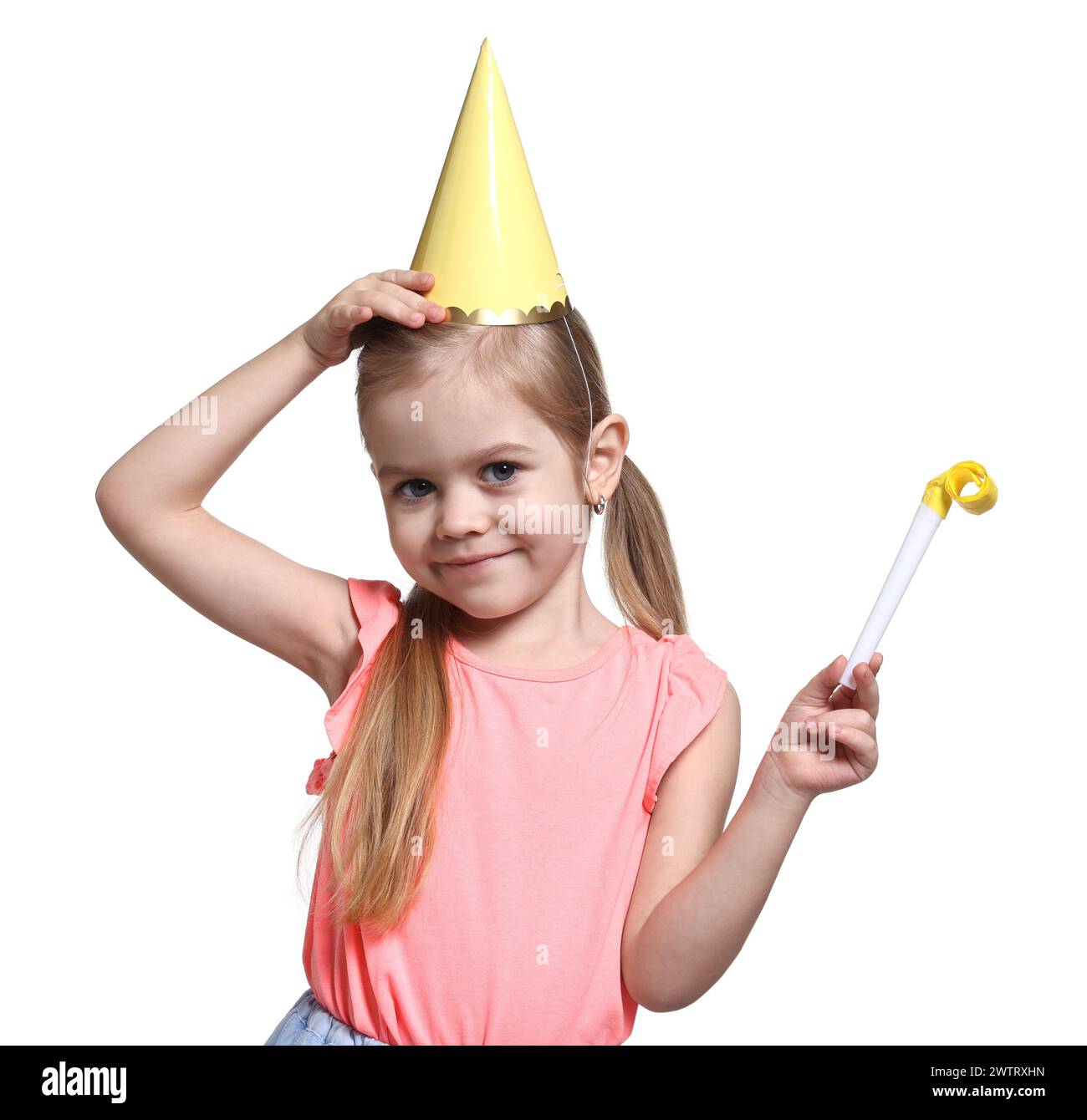 Birthday celebration. Cute little girl in party hat with blower on ...