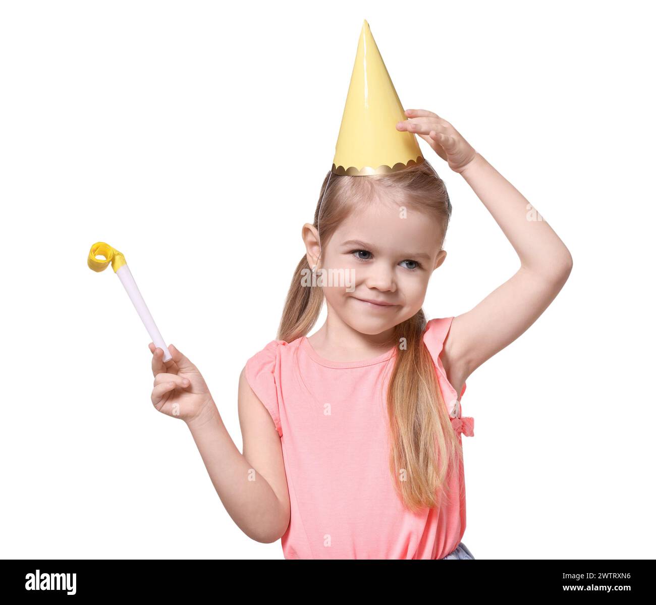 Birthday celebration. Cute little girl in party hat with blower on ...