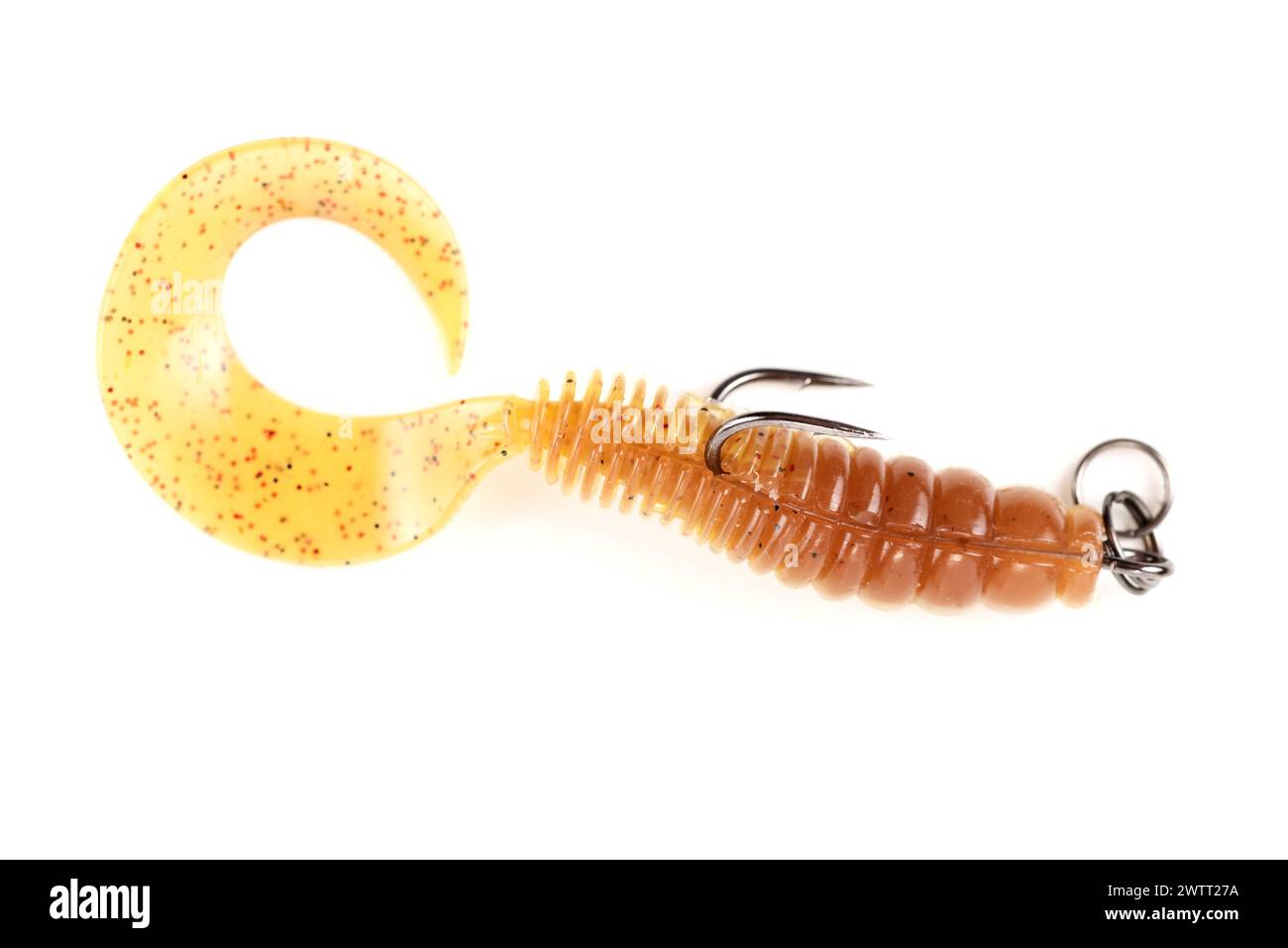 Yellow silicone grub, fishing lure with double hook, isolated on white background Stock Photo