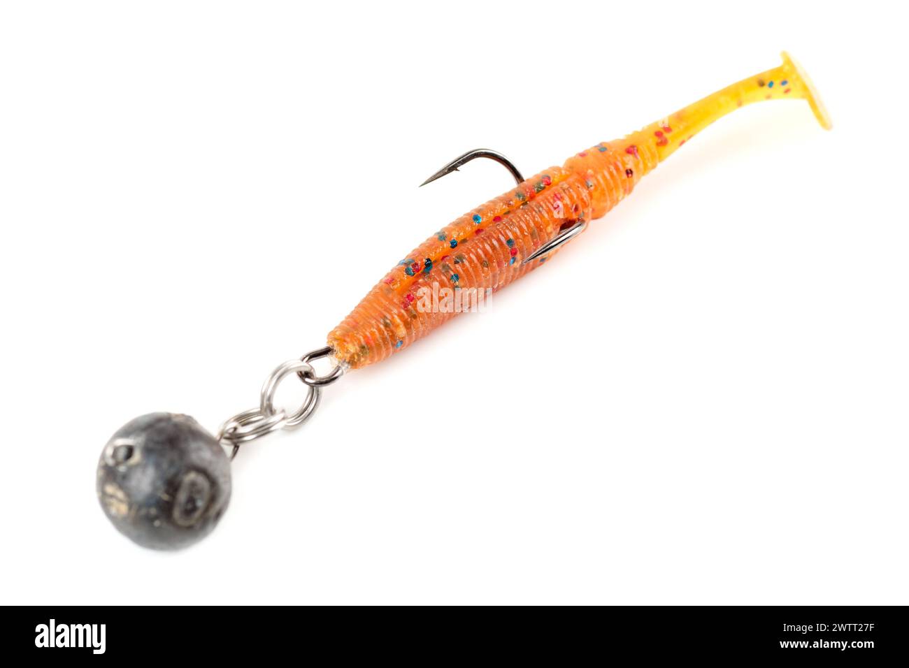 Orange fishing lure, plastic shad fish, with double hook and lead sinker, isolated on white background Stock Photo