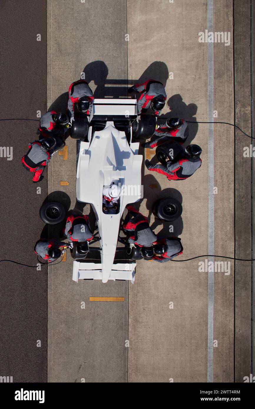 Pit stop precision A topdown view of a racing team in action. Stock Photo