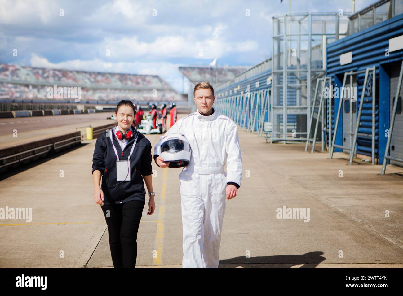 racing-team-members-standing-confidently-on-the-track-with-equipment