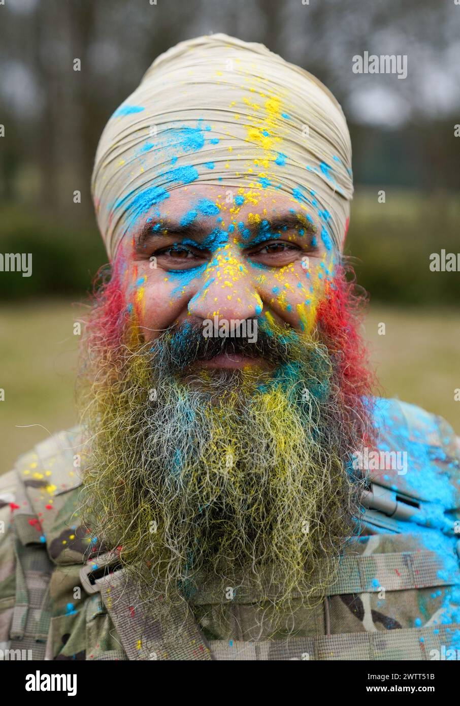 Major Harj Singh Shergill poses for a photograph with powdered paint on his face during the Holla Mahalla Sikh military festival, at the Aldershot Garrison, Hampshire. The centuries old Hola Mahalla festival celebrates Sikh martial traditions, and promotes courage, preparation, and readiness. Picture date: Tuesday March 19, 2024. Stock Photo