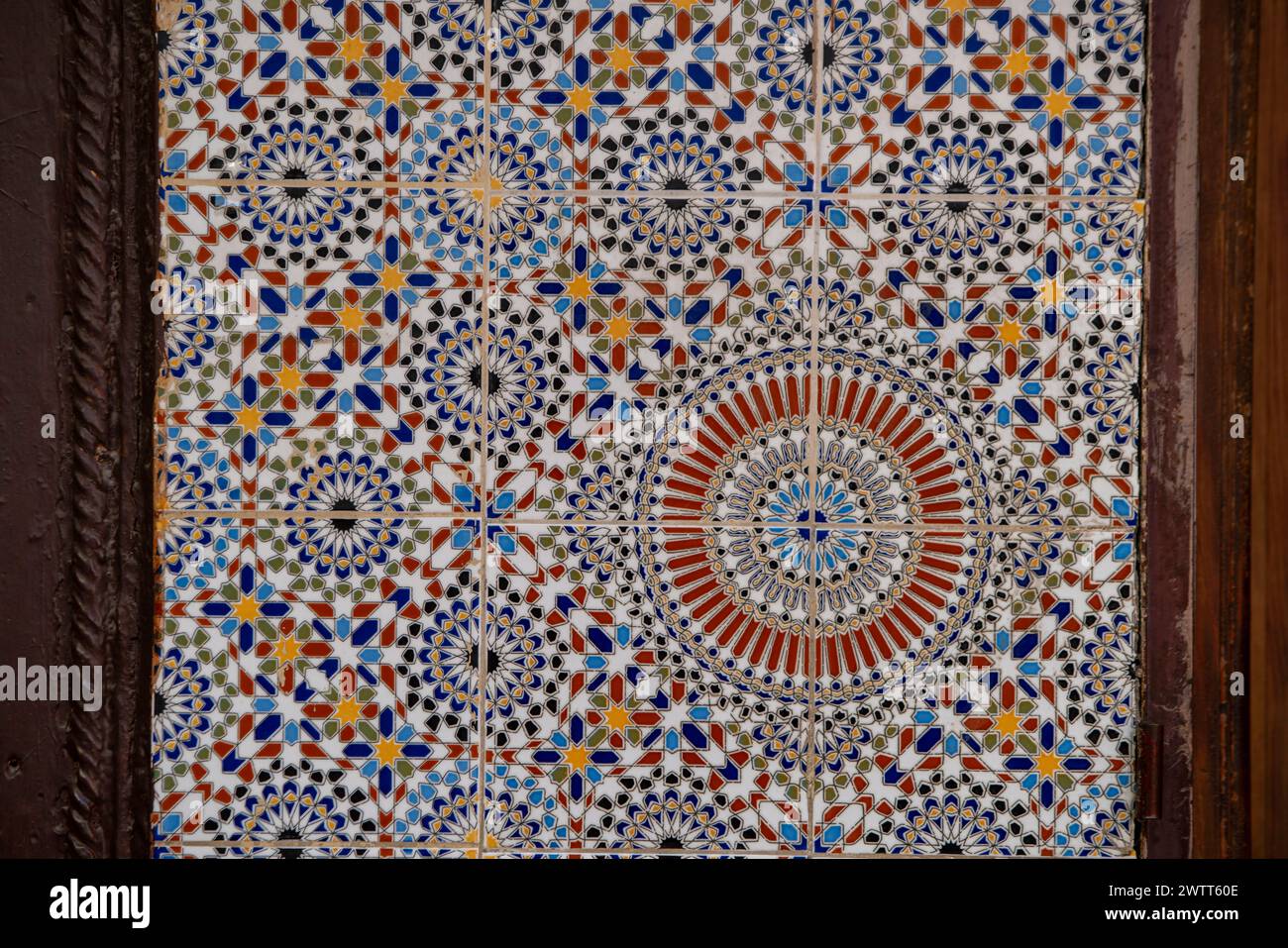 Tile work with Moorish geometric patterns at  historic Medersa Bou Inania, Medina, Fez, Morocco Stock Photo