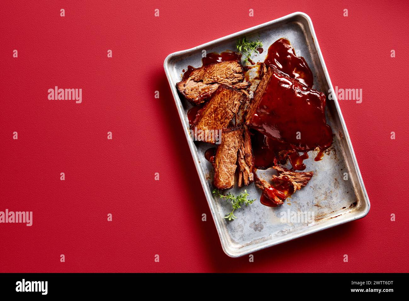Delicious brisket on a tray with savory sauce Stock Photo
