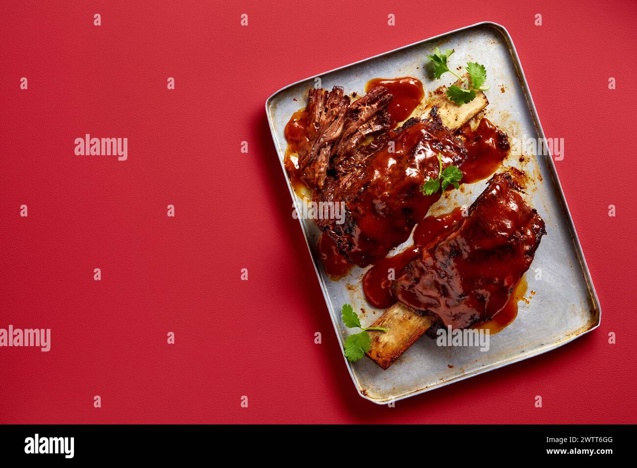 A delicious serving of barbecue ribs on a plate, ready to be enjoyed. Stock Photo