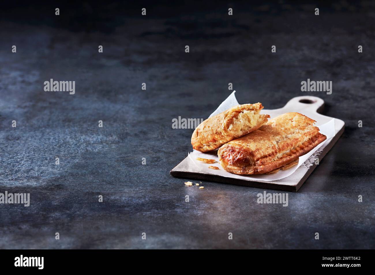 Freshly baked pastries on a dark, textured countertop Stock Photo