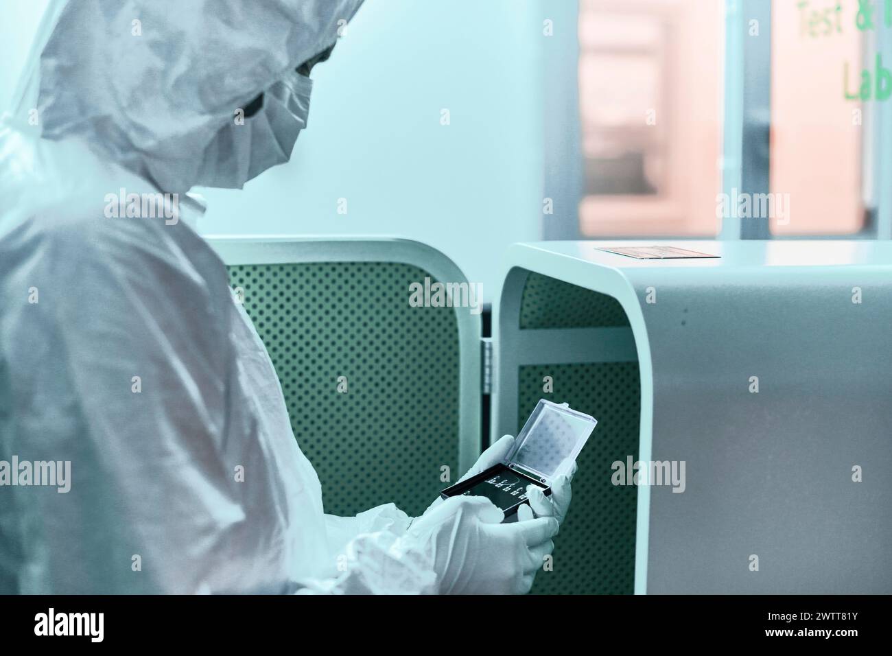 Experienced labratory scientist examining dna experiement testing equipment in the labratory sealed containment fridge Stock Photo