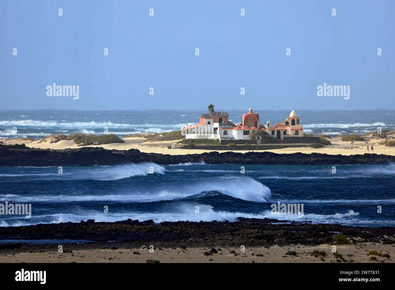 View of rough sea looking towards the Dream House, la Concha Beach, El Cotillo, Fuerteventura, Canary Islands, Spain. Stock Photo