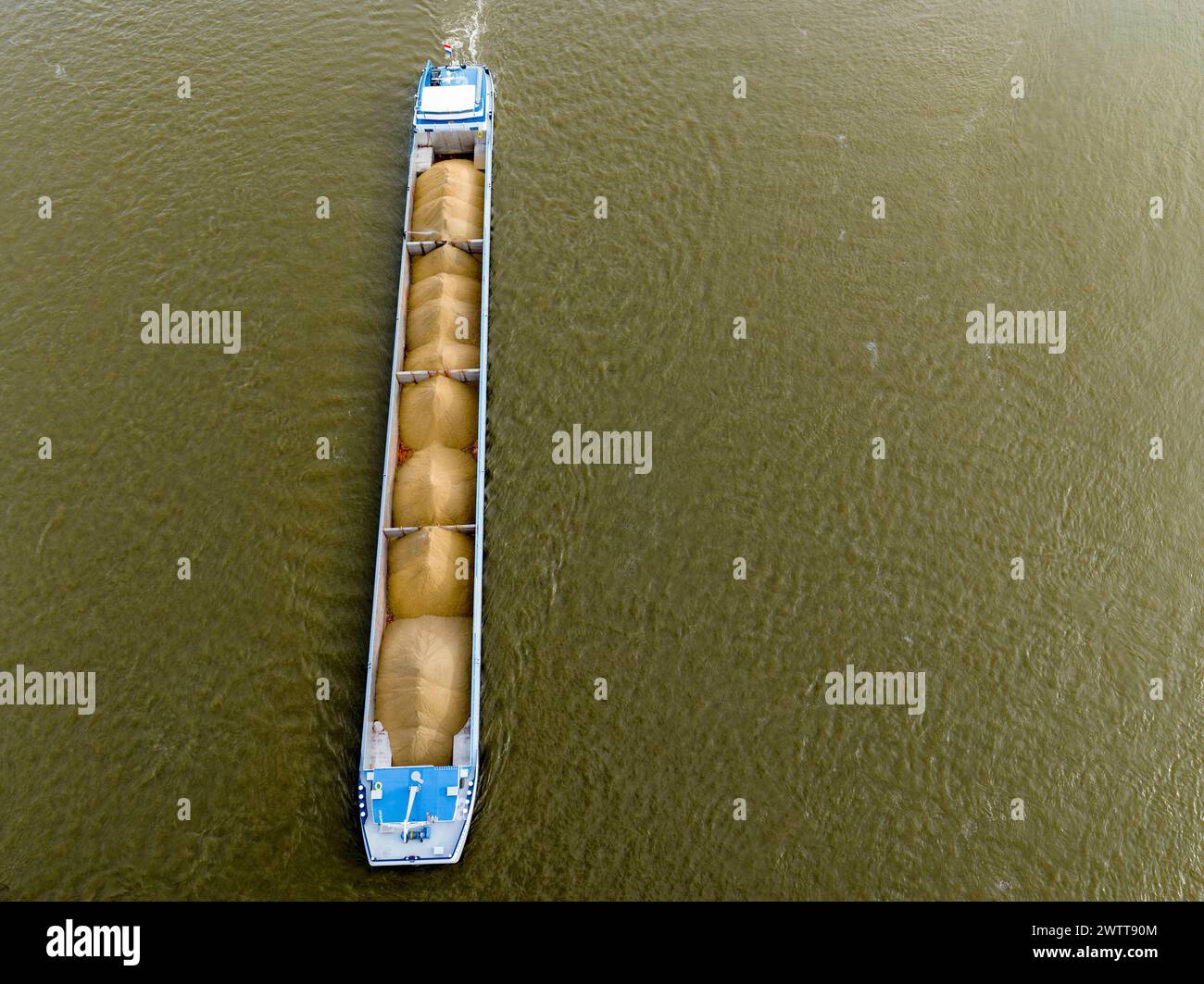 Aerial view of a cargo ship navigating through a river Stock Photo